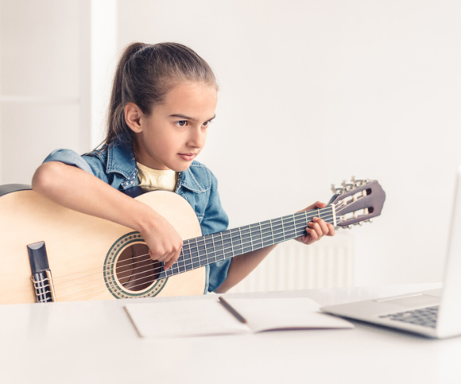 focused girl practicing guitar