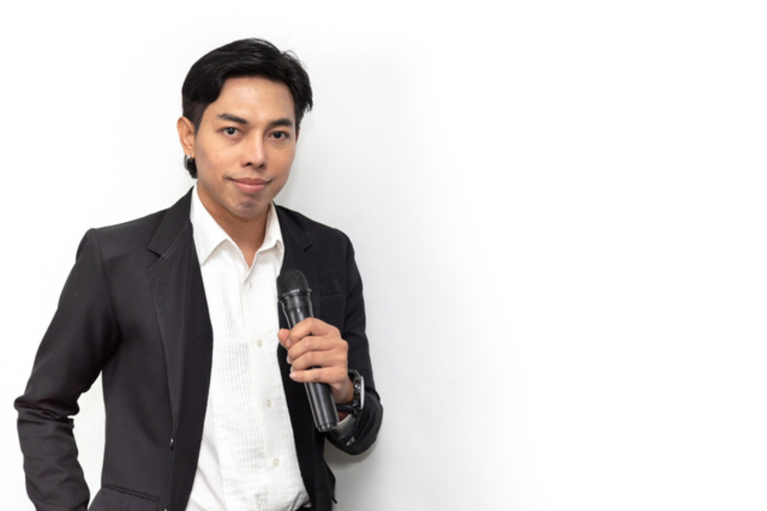 asian business man smiling and holding a microphone showing confident speaking ability