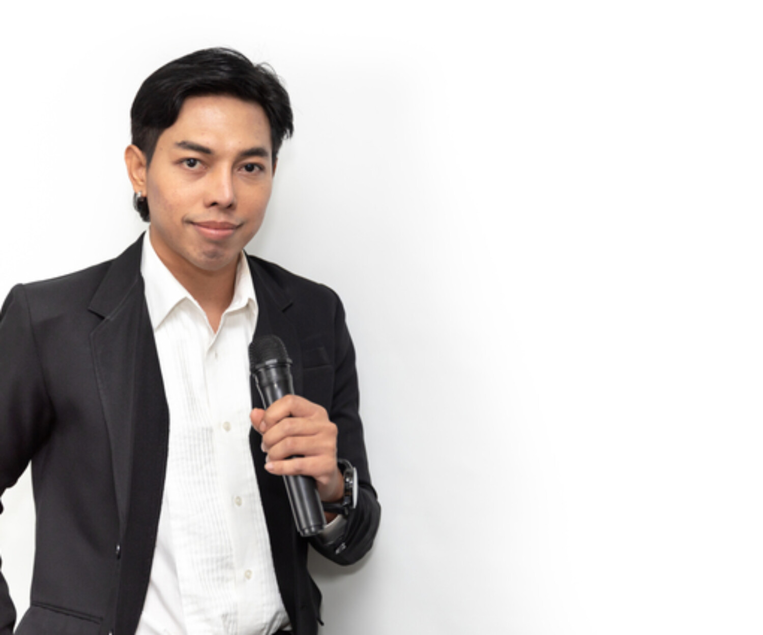 asian business man smiling and holding a microphone showing confident speaking ability